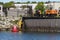 Worker doing maintenance on steel sheet pile wall on New Bedford waterfront