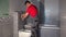 Worker draw water from pipe of toilet flushing mechanism