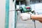 Worker drilling with machine in construction site wall