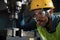 Worker Drilling machine hole metal flat steel plate and selective focus with bench drill in the factory, Close- up on the face