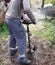 A worker is drilling soil for a gate