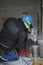 a worker drills a concrete main deme with a huge core drill