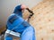 Worker drills holes in the wall with a perforator