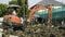 Worker drive orange excavator or macro truck working in house construction site