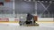 Worker Drives Ice Harvester with Logo Olympia on Rink