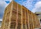 Worker driving forklift loading shipment carton boxes goods on wooden pallet at loading dock from container truck to warehouse car