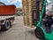 Worker driving forklift to loading and unloading wooden pallets from truck to warehouse cargo storage, shipment in logistics and