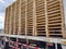 Worker driving forklift to loading and unloading wooden pallets from truck to warehouse cargo storage, shipment in logistics