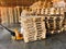 Worker driving forklift to loading and unloading wooden pallets from truck to warehouse cargo storage, shipment in logistics and t