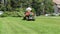 Worker Driving Lawn Mower