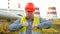 Worker, engineer, or electrician looking at the camera employee shows how to work standing in front of a power station