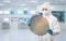 Worker or engineer wears medical protective suit or coverall suit with silicon wafer