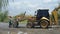 Worker and excavator loader backhoe in construction site