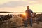 Worker feeding cows with hay on farm. Animal husbandry