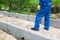 Worker feet stand on unfinished road, bottom view