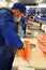 A worker is filleting salmon in a seafood supermarket in Vietnam