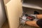 Worker fixing cabinet door hinge on kitchen cabinets