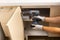 Worker fixing cabinet door hinge on kitchen cabinets