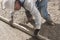 A worker flattening fresh cement