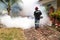 Worker fogging residential area with insecticides to kill aedes