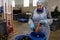 Worker of food processing plant shredding zucchini