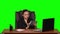 Worker girl sits at a workplace leaning back in a leather chair and communicates on a tablet and angry. Green screen