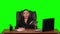 Worker girl sits at a workplace leaning back in a leather chair and communicates on a tablet and upset. Green screen