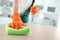 Worker in gloves cleaning table with rag, closeup