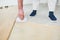 Worker gluing wood parquet floor.