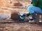 Worker grinds the concrete of angular grinding