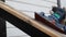 Worker grinds the inclined surface of a wooden railing with a vibrating machine