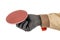 Worker hand in black protective glove and brown uniform holding angle grinder quick release holder for sanding paper discs