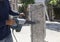 Worker hand drilling on concrete pole for construction building