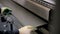 Worker hands bend metal sheet on a modern bending industrial machine at a factory.