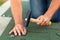 Worker hands installing bitumen roof shingles - horizontal crop