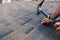 Worker hands installing bitumen roof shingles. Worker Hammer in Nails on the Roof. Roofer is hammering a Nail in the Roof Shingles