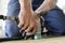 Worker hands making holes with a drill on the body plane for further riveting