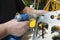 Worker hands making holes with a drill on the body plane for further riveting, planes assembly hall