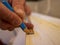 Worker hands marking with pencil a strip