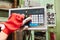 Worker hands operate keyboard of a CNC machine