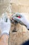 worker hands taking notes and drawing on stone. Construction worker paving home facade with stone