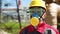 Worker in hard hat, goggles and respirator at power station