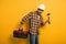 Worker in hardhat holding toolbox and