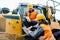 Worker with heavy excavation machinery in mining operation