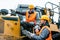 Worker with heavy excavation machinery in mining operation