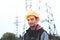 Worker in a helmet against the background of a substation