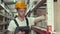 Worker in helmet is checking materials at the factory