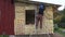 Worker with helmet insulating with rock wool wooden house wall