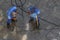 Worker with high pressure water cleaner cleans a stone surface