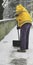 Worker with high visibility jacket while shoveling snow from fro